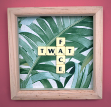 Load image into Gallery viewer, Framed wall art collage with Tropical leaf background and "twat face" written in scrabble tiles