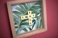 Load image into Gallery viewer, Framed wall art collage with Tropical leaf background and &quot;twat face&quot; written in scrabble tiles 
