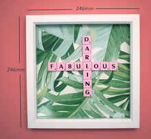 Load image into Gallery viewer, Characterful and colourful scrabble art with a green tropical leaf paper background and &#39;Fabulous Darling&#39; written in pink vintage scrabble tiles presented in a white box frame 
