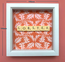 Load image into Gallery viewer, Characterful and colourful scrabble art red patterned background with &#39;Lobster&#39; written in vintage scrabble tiles presented in a white box frame 
