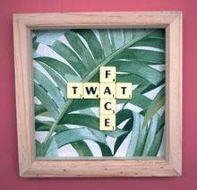 Load image into Gallery viewer, Framed wall art collage with Tropical leaf background and &quot;twat face&quot; written in scrabble tiles 
